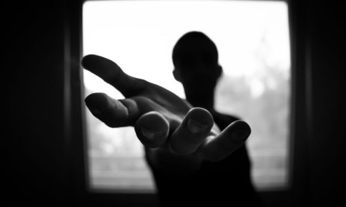 a man standing in front of a window